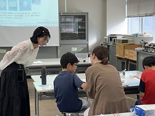 写真3 専攻科2年 小野さん（左）の工作指導