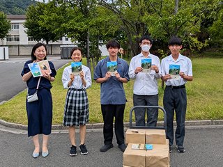 完成した絵本を運びながら記念撮影